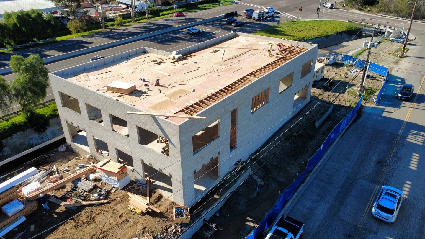Crane and lumber staging beside the building
