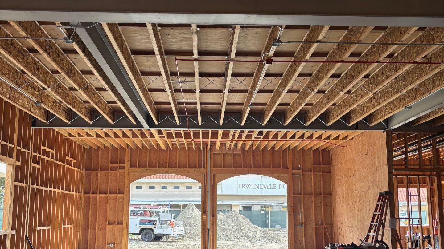Roof joists spanning the main room, windows framed to the street
